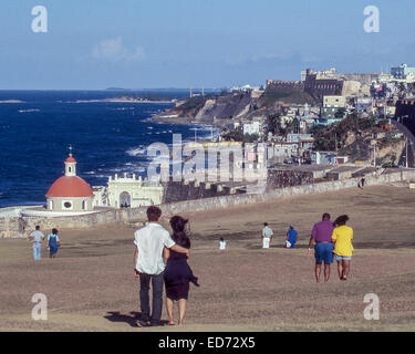 April 3, 2001 - San Juan, Puerto Rico, US - Local residents and tourists walk across the large esplanade of the famed Castillo San Felipe del Morro (Morro Castle), the historic 16th-century citadel on the northwestern-most point of the islet of Old San Juan, Puerto Rico. At bottom (left), outside the wall, is the red-domed Renaissance Revival chapel of the historic city cemetery. On the horizon, (top right) are the walls of the Castillo de San Cristobal, the 1783 Spanish built fortress. (Credit Image: © Arnold Drapkin/ZUMA Wire) Stock Photo