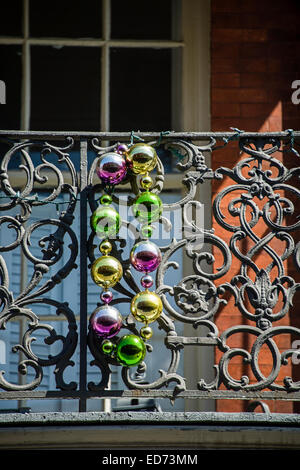 A balcony in the French Quarter of New Orleans, Louisiana with giant shiny Mardi Gras beads Stock Photo