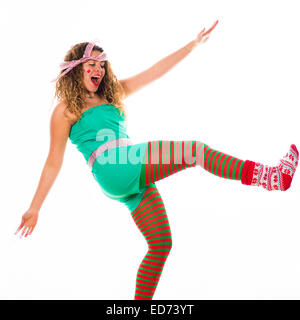 Office Party Animals: A young woman girl enjoying herself dancing wilkdly with her arms outstretched at  a Christmas Xmas theme fancy dress 'office party' christmas party, UK Stock Photo