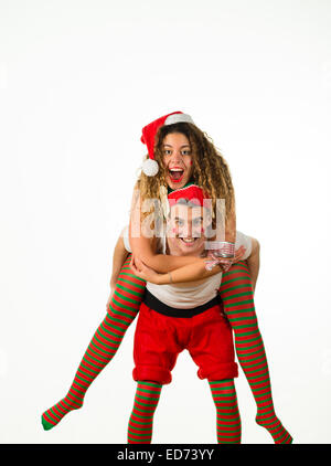 Office Party Animals: A young couple boy girl man woman having fun enjoying themselves  at  a Christmas Xmas theme fancy dress 'office party' christmas party, UK Stock Photo