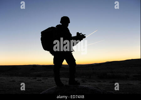 A British soldier on patrol as the Sun rises at Sennybridge Training Area, Wales, United Kingdom.