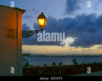 San Juan, Puerto Rico, US. 12th Jan, 2009. An old-fashioned wrought-iron city light hangs on the old city wall at the Parque de las Palomas (Pigeon Park) in El Viejo San Juan (Old San Juan), Puerto Rico, overlooking San Juan Bay. © Arnold Drapkin/ZUMA Wire/Alamy Live News Stock Photo