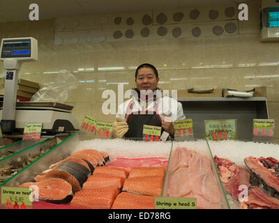 Proud fishmonger in Asian market in Albany, New York. Stock Photo