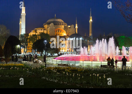 Hagia Sophia Muslim mosque museum and Atmeydani Hippodrome fountain floodlit at night, Istanbul, Turkey Stock Photo