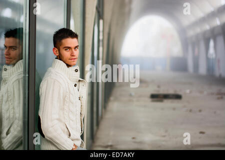 Attractive young man in abandoned empty tunnel Stock Photo