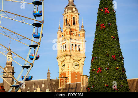 Lille, Pas de Calais, France. Ferris wheel, Clock Tower of the Chambre de Commerce, and Christmas Tree at the Christmas Market Stock Photo