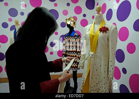 A young Bhutanese woman checks the quality of a garment at the Bhutan Textile Museum or the National Textile Museum which display Bhutan's achievements in the field of textile arts and to sustain and promote interest of the weavers to continue the traditional textile patterns located in the city of Thimphu capital of Bhutan Stock Photo