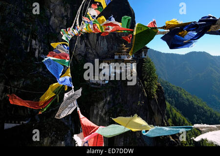 View across Lung Ta Tibetan Buddhist Prayer Flags of Paro Taktsang also known as the Taktsang Palphug Monastery and the Tiger's Nest) a prominent Himalayan Buddhist sacred site and temple complex located in the cliffside of the upper Paro valley in Bhutan. Stock Photo