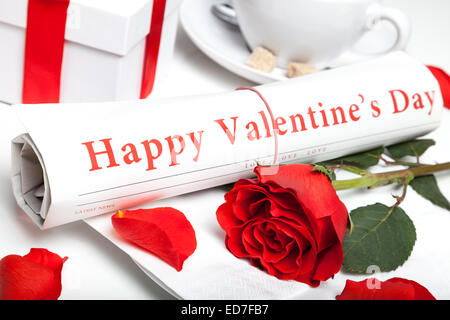 'happy valentine's day' newspaper, red rose and present box Stock Photo