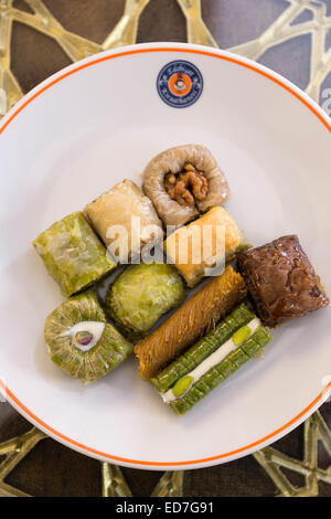 Plate of traditional Turkish honey covered sweetmeats, baklava, dessert of filo pastry and nuts, Istanbul, Turkey Stock Photo