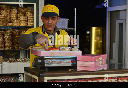 Cairo, Egypt. 29th Dec, 2014. An Egyptian man sells sweets in preparation to celebrate the birthday of prophet Muhammad, also known as ''Mawlid Nabawi'', which will fall next week, in Cairo, December 31, 2014 © Amr Sayed/APA Images/ZUMA Wire/Alamy Live News Stock Photo