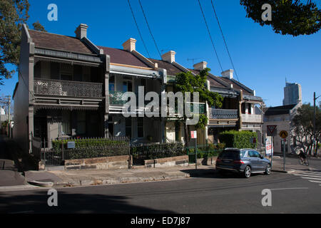 Cyclists passing Victorian Terrace Houses in Paddington Sydney Australia Stock Photo