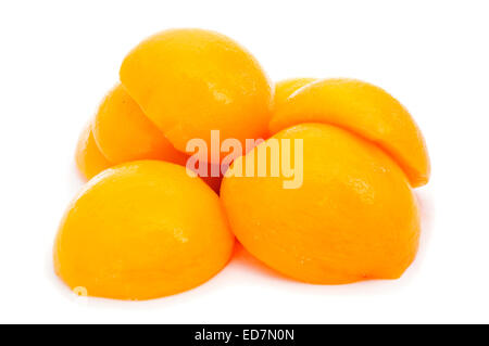 some peeled and halved peaches in syrup on a white background Stock Photo