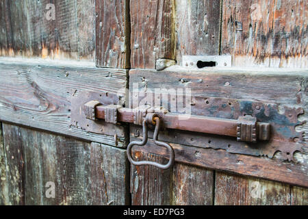 deadbolt on old wooden door Stock Photo