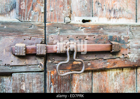 deadbolt on old wooden door Stock Photo