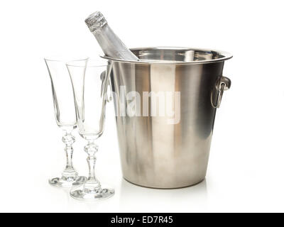 New Year champagne bottle in metal cooler and two champagne glasses shot on white Stock Photo
