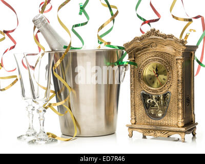 New Year champagne bottle in cooler, two champagne glasses and table clock showing midnight shot on white Stock Photo
