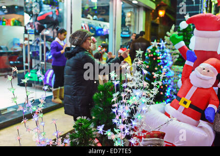 A woman takes photos in front of red lantern decorations in Thean Hou ...