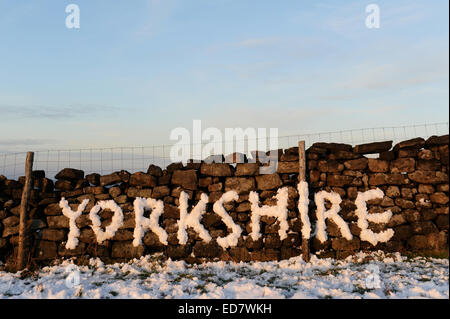 The word ' YORKSHIRE ' written in snow on a stone wall Stock Photo