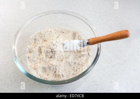 Mixing bread flour mix and rubbed in butter with a palette knife Stock Photo