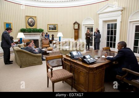US President Barack Obama speaks on the phone with Texas Governor Rick Perry to make sure he has the resources necessary to deal with the Ebola outbreak from the Oval Office of the White House October 16, 2014 in Washington, DC. Stock Photo