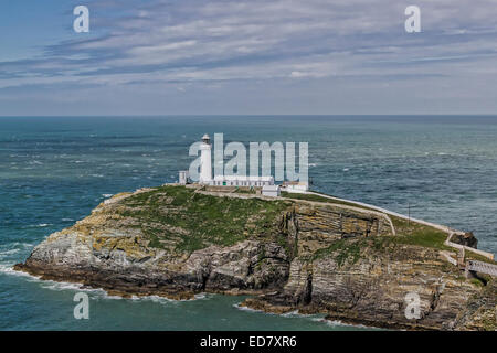 South Stack  lighthouse and tourist attraction. Set against a clear blue sea and cloudy sky Stock Photo