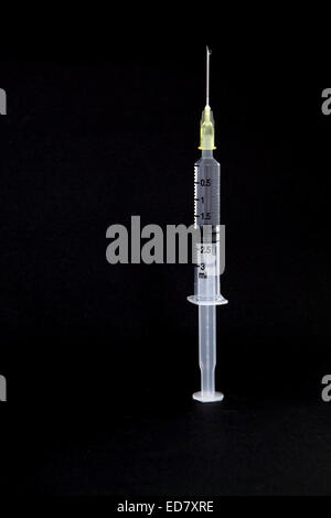 isolated syringe with needle and water drop on black background Stock Photo