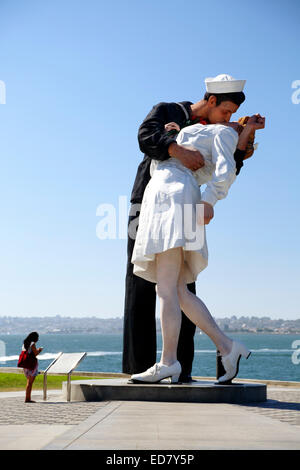 Woman and 'Unconditional Surrender' sculpture (sailor kissing a nurse), by Seward Johnson, San Diego, California USA Stock Photo