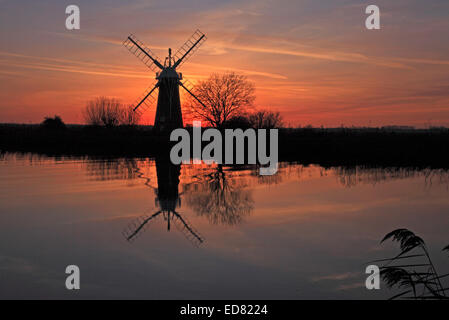 A sunset on the River Thurne with windmill on the Norfolk Broads at Thurne, Norfolk, England, United Kingdom. Stock Photo