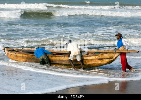 Launching a fishing boat at Prampram, Greater Accra, Ghana, Africa Stock Photo