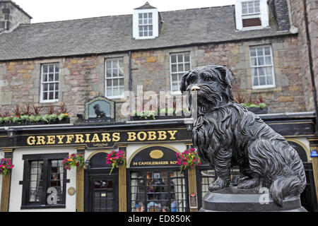Statue of Greyfriars Bobby, with public house of same name in background, Edinburgh, Scotland Stock Photo