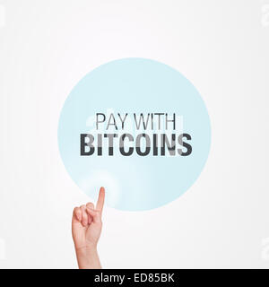 Pay With Bitcoins Concept, finger pushing circular touchscreen button on web page for online purchase. Stock Photo
