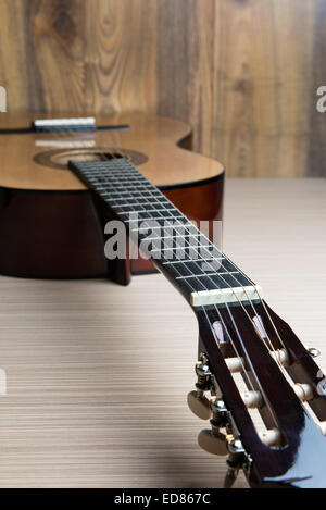 acoustic six-string guitar on the background of wooden panels Stock Photo