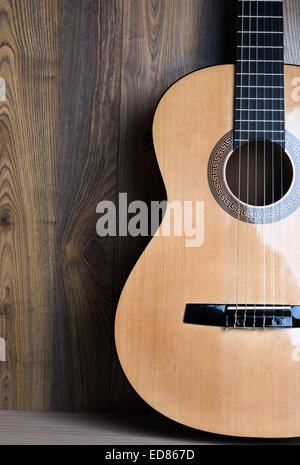 acoustic six-string guitar on the background of wooden panels Stock Photo