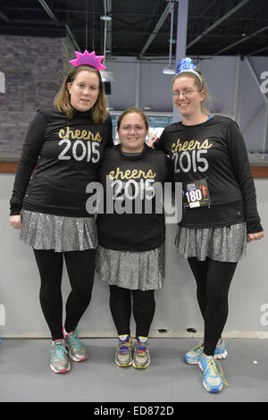 East Meadow, New York, USA. 31st Dec, 2014. L-R, HEATHER SOFTY of Bethpage, friend CHRISTINA PIETRAS, of Westbury, and sister LAURA SOFTY, of Bethpage, are wearing race bib identification and sparkly black shirts that say ''cheers 2015'' before participating in a 5K New Year's Eve DASH to support the Long Island Council on Alcoholism and Drug Dependence (LICADD) at the Twin RInks Ice Center at Eisenhower Park in Long Island. The Softy sister are members of Greater Longg Island Running Club (GLIRC). A Skatin' New Year's Eve event started hours earlier and a New Year's Eve Party, open Stock Photo