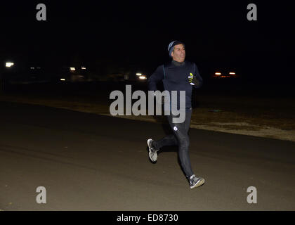 East Meadow, New York, USA. 1st Jan, 2015. A runner participates in a 5K New Year's Eve DASH to support the Long Island Council on Alcoholism and Drug Dependence (LICADD) at the Twin RInks Ice Center at Eisenhower Park in Long Island. A Skatin' New Year's Eve event started hours earlier and a New Year's Eve Party, open to runners, family and friends continued until 2:30 a.m. © Ann Parry/ZUMA Wire/Alamy Live News Stock Photo