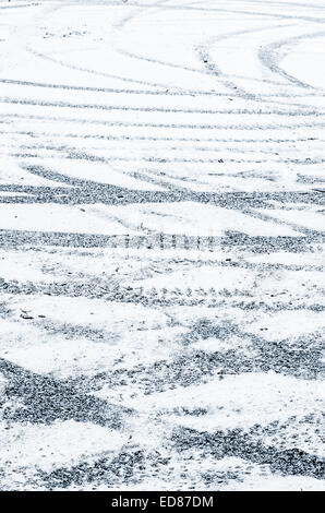tire tracks on ground covered with snow Stock Photo