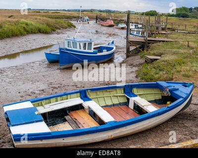 Small boats moored in the old harbour at Thornham North Norfolk Stock Photo