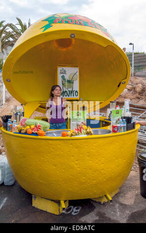 A woman serving in a fresh fruit drink stall in Los Cristianos market the largest market in the Canary Islands Stock Photo