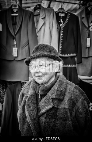 Sales person at Rozycki Bazaar in front of her merchandise Stock Photo