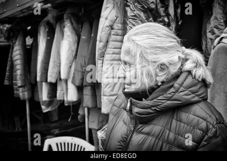 Sales person at Rozycki Bazaar in front of her merchandise Stock Photo