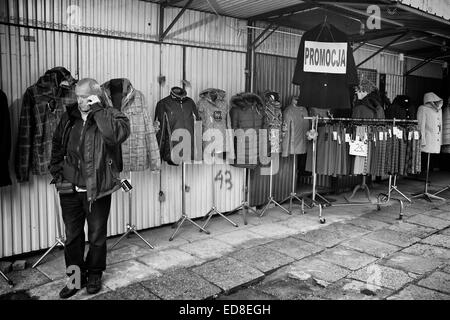 Sales person at Rozycki Bazaar in front of his merchandise Stock Photo