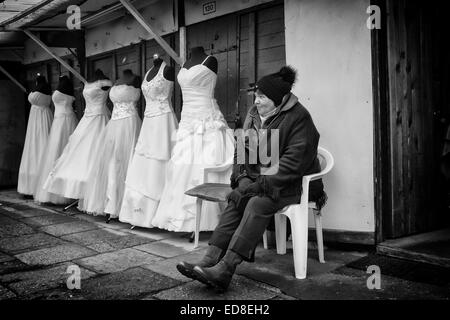 Sales person at Rozycki Bazaar in front of her merchandise Stock Photo