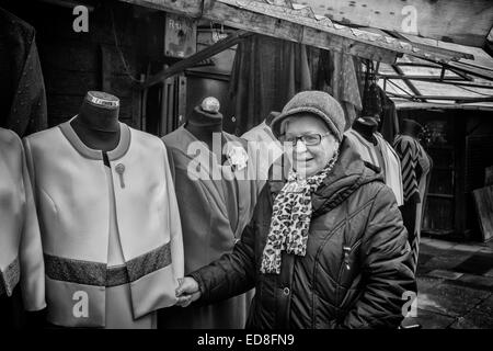 Sales person at Rozycki Bazaar in front of her merchandise Stock Photo