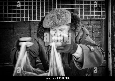 Sales person at Rozycki Bazaar in front of her merchandise Stock Photo