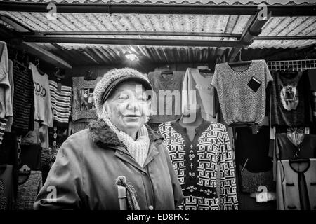 Sales person at Rozycki Bazaar in front of her merchandise Stock Photo