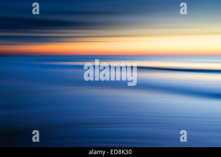 Sunrise at the beach with ICM (intentional camera move) achieved by panning the camera and blurring the image to give abstract s Stock Photo