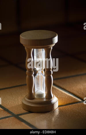 timer hourglass streaming grains of sand flowing through depicting things are running out