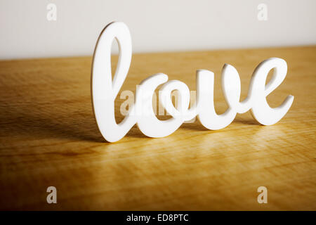 Love sign on wooden table. Stock Photo