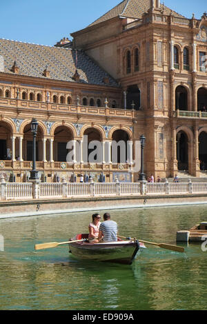 Seville Spain: Couple rowing on the boating canal at the Plaza de Espana Stock Photo